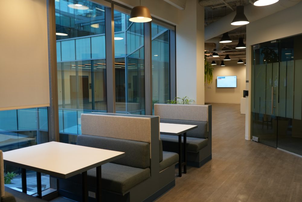 Booth seating beside the atrium windows